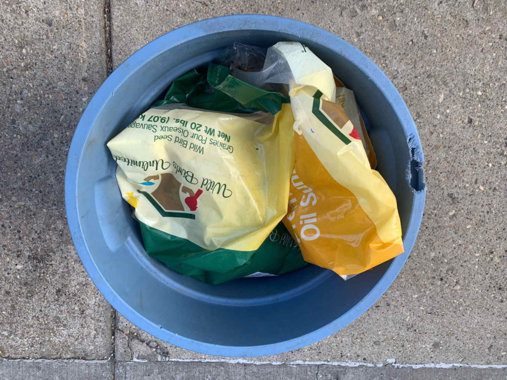 Garbage bin as bird seed storage
